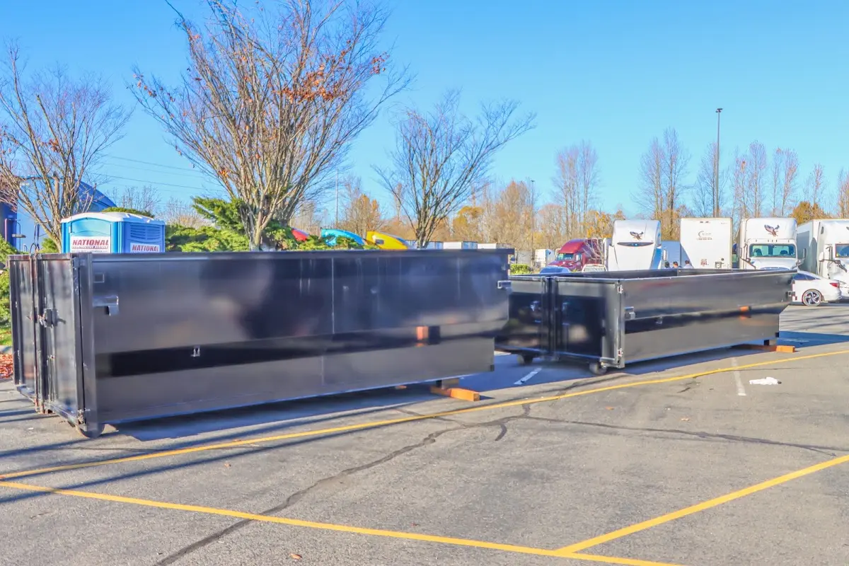 Professional dumpster rental service with roll-off container on residential driveway in Big Bear Lake